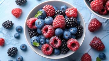 Fresh Mixed Berries in White Bowls on Light Blue Wooden Table - Raspberries, Blueberries, and Blackberries photo