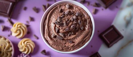 Delicious Chocolate Mousse in a White Bowl with Chocolate Shavings on a Purple Background photo