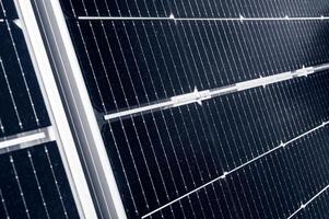 texture of cell elements of a modern black solar panel close-up. Renewable green energy photo