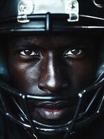 American football player wearing helmet gazing with intensity photo