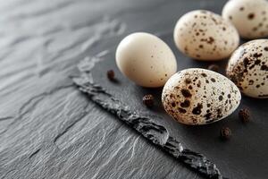 Fresh Quail Eggs on Slate Background with Natural Light and Textures photo