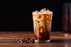 Iced coffee in a glass on a wooden table photo