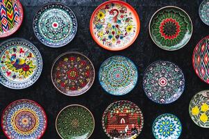 oriental Uzbek ceramic plates hand-painted on black background photo