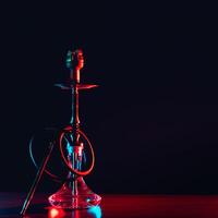 hookah shisha with coals on the table on a black background photo
