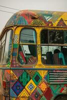 Colorful Vintage Bus Covered with Artistic Patterns in Urban Setting photo