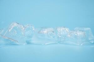 transparent clean ice cubes on a blue background photo