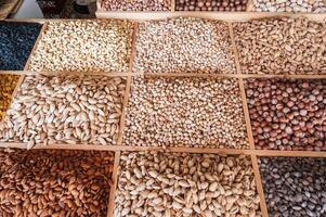 assortment of different variety nuts on counter at eastern Uzbek food bazaar. Almonds, pistachios, hazelnuts, macadamia, pecans and cashews photo