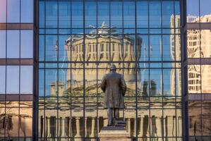 McKinley memorial in front of a reflection of the Ohio state Capitol building in the windows of an office building across the street in Columbus, OH photo