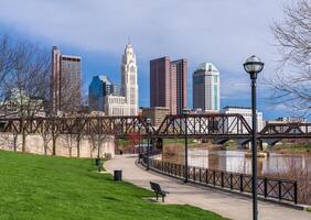 Columbus Ohio waterfront view of the downtown financial district from the River Scioto through a railroad truss bridge photo