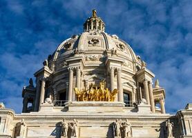 Front view of the dome and gold Quadriga statue of the Capitol building in the state of Minnesota in Saint Paul, MN photo