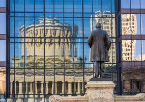 McKinley memorial in front of a reflection of the Ohio state Capitol building in the windows of an office building across the street in Columbus, OH photo