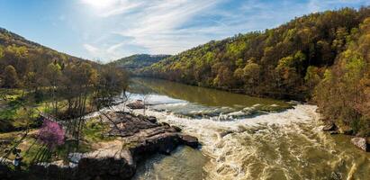 Aerial view of Valley Falls State Park near Fairmont in West Virginia on a spring day with redbud blossoms on the trees photo