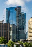 Austin, Texas - 15 June 2024. Indeed HQ skyscraper soars above older historic stone buildings in Austin, TX photo