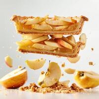 A delicious apple pie topped with apples and crumbly crust. The pie is freshly made, photo