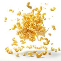 Macaroni and cheese shells splattered against a white background. photo