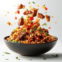 Savory beef and rice stir fry bursting with aromatic spices, served in a black bowl. photo