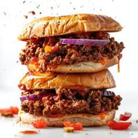 a stack of hamburgers with meat and vegetables photo