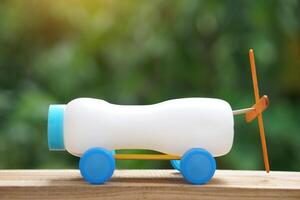 Handmade toy racing car made from ice cream sticks and bottle caps. Concept, Recycling kids toy. Easy to do, creative DIY craft that kids can do. Recycle invention. photo