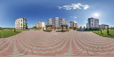 360 hdri panorama in middle of modern multi-storey multi-apartment residential complex of urban development in equirectangular seamless spherical projection, AR VR content photo