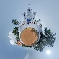 little planet transformation of spherical panorama 360 degrees overlooking church in center of globe in blue sky. Spherical abstract aerial view with curvature of space. photo