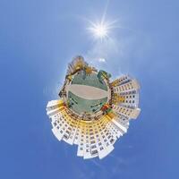 abstract swirling tiny planet spherical panorama of multi-storey buildings of skyscrapers of a residential complex in the form of a butterfly, bugs, crabs in blue sky photo
