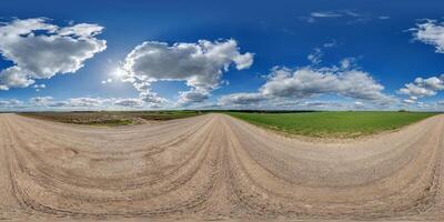 spherical 360 hdri panorama on gravel road with white clouds in blue sky in equirectangular seamless projection, as skydome replacement in drone panoramas, game development photo