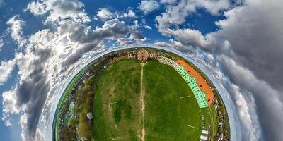 tiny planet and spherical aerial panorama view on street ancient medieval castle and historic buildings in blue sky with clouds photo