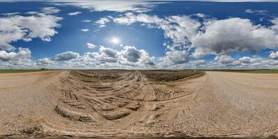 blue skydome hdri 360 panorama with awesome clouds on gravel road among fields in spring day in equirectangular full seamless spherical projection, for VR AR content or sky replacement photo