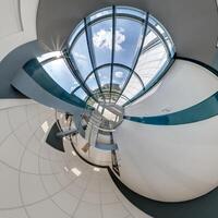 abstractly twisted into spherical 360 panorama interior of modern office with hall staircase and panoramic windows photo