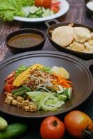 Close up of gado-gado ingredients in a plate, various vegetables and fried tempeh photo