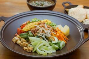 Close up of gado-gado ingredients in a plate, various vegetables and fried tempeh photo