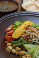 Close up of gado-gado ingredients in a plate, various vegetables and fried tempeh photo