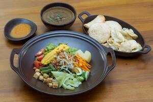 Close up of gado-gado ingredients in a plate, various vegetables and fried tempeh photo