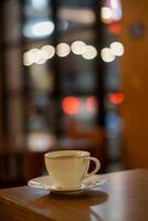 Cup of coffee on the table with bokeh blur background photo