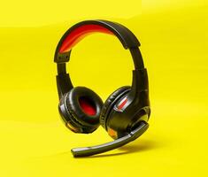 Wireless Over-Ear full size Headphones, Black leather isolated on yellow background with clipping path. photo
