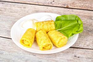 Stuffed pancakes with cream sauce photo