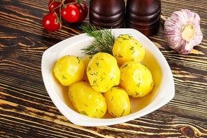 Boiled potato with oil and dill photo