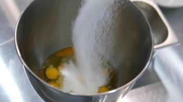 Sugar and eggs Chicken eggs are mixed with sugar in a mixer. Confectionery production. Concept of cakes and pastries video