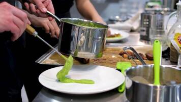 Mashed green peas. Puree mashed potatoes with green pea in bowl on wooden table video
