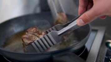 Fry beef in a frying pan falling beef steak on wok pan and fire blast on black background. Filmed on high speed cinema camera, video