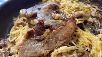 Heat the meat with vermicelli in a frying pan Close-up shot of stir-fried vermicelli being placed on a plate ready to be served. video