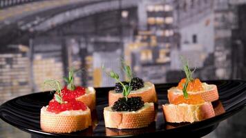 Sandwiches with caviar food background. several sandwiches with red caviar rotate on a plate. close-up. video