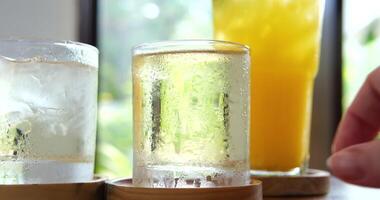 Cold juice Macro refreshing soda tonic fizzy sparkling water, lime in glass, ice cubes. Slice of lemon, mineral bubbles. Healthy, dietary nutrition. Cold lemonade mojito cocktail twinkling carbonated video