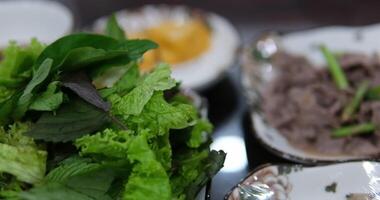 Mint basil lettuce leaves fresh vibrant collard greens in bowl on textured green background video