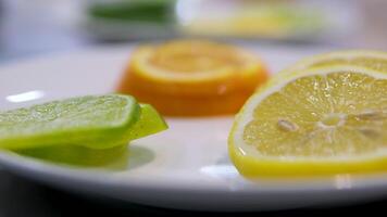 Making lemonade, summer drink, cold drink, healthy liquid. Lemon orange lime, making a cocktail of citrus fruits, drinking cold lemonade, shooting of carbonated water with sliced fruits. video