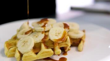 Delicious Belgian waffles with banana, whipped cream and caramel sauce video