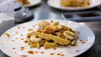 Delicious Belgian waffles with banana, whipped cream and caramel sauce video
