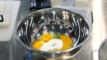 Eggs and sugar Preparing to make sweet tamagoyaki. A of adding sugar to raw eggs and mixing them. video