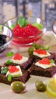 Sandwiches with caviar food background. several sandwiches with red caviar rotate on a plate. close-up. video