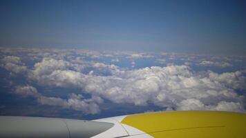 Clouds from the airplane window. A view of the sky with clouds and a wing of an airplane video